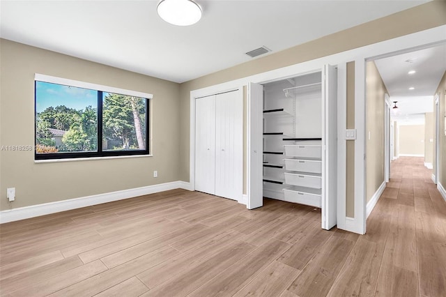 9745 SW 126th Ter, Miami, FL 33176 - unfurnished bedroom featuring light wood-style floors, multiple closets, and recessed lighting