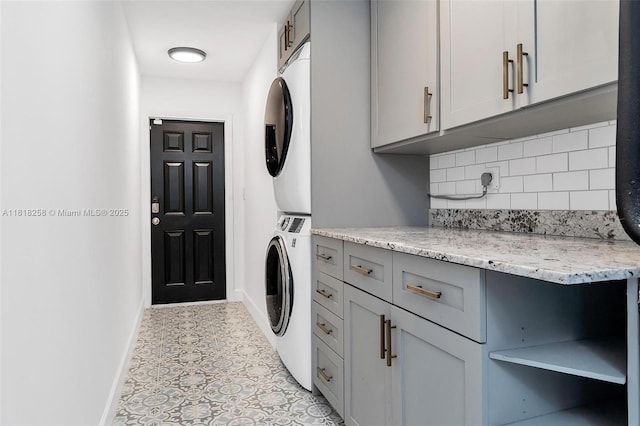 9745 SW 126th Ter, Miami, FL 33176 - laundry area with stacked washer / dryer, cabinet space, and tile patterned floors