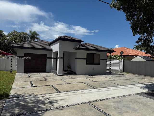 14480 SW 112th St, Miami, FL 33186 - prairie-style home with stucco siding, a garage, a tiled roof, and driveway