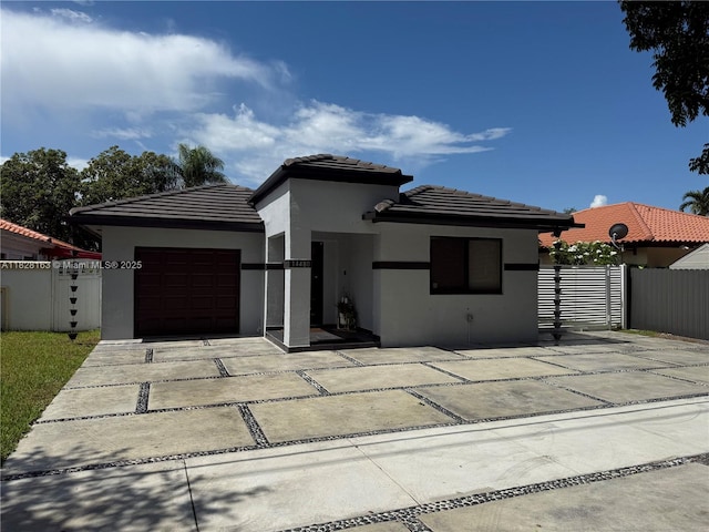 14480 SW 112th St, Miami, FL 33186 - view of front of house featuring stucco siding, a garage, driveway, and a tiled roof