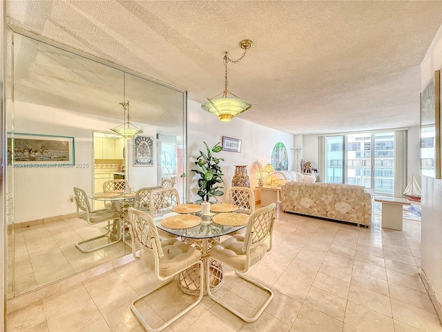 5701 Collins Ave Unit 417, Miami Beach, FL 33140 - dining area featuring tile patterned floors and a textured ceiling