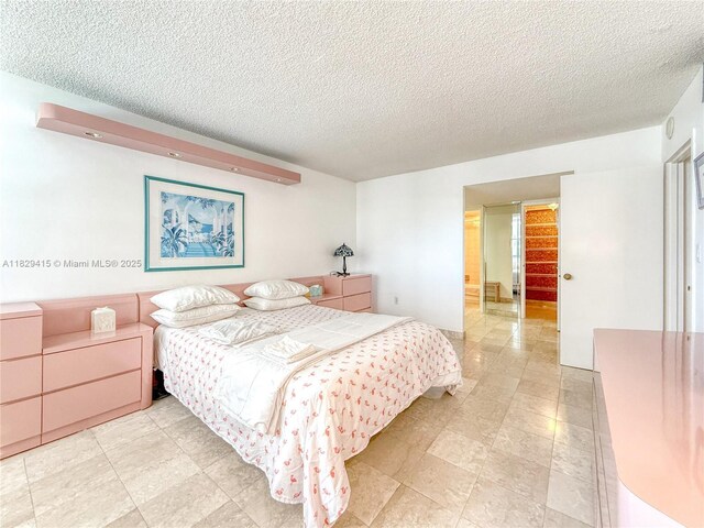 5701 Collins Ave Unit 417, Miami Beach, FL 33140 - bedroom featuring a textured ceiling