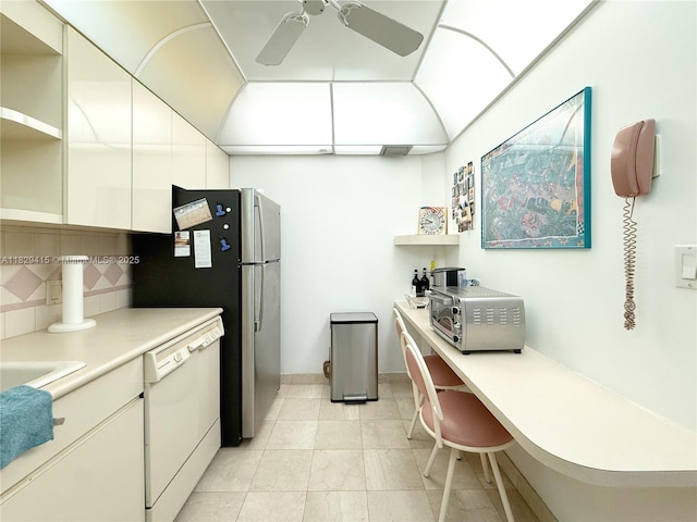 5701 Collins Ave Unit 417, Miami Beach, FL 33140 - kitchen featuring open shelves, white dishwasher, ceiling fan, tasteful backsplash, and a desk