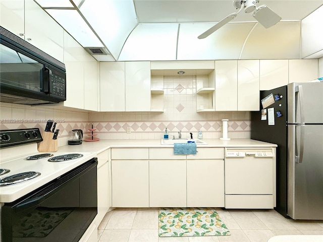 5701 Collins Ave Unit 417, Miami Beach, FL 33140 - kitchen with dishwasher, electric range, black microwave, freestanding refrigerator, and open shelves