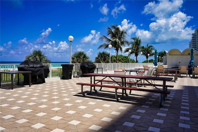 5701 Collins Ave Unit 417, Miami Beach, FL 33140 - view of patio with area for grilling, outdoor dining area, and a water view