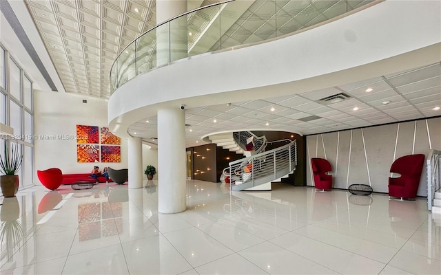 5701 Collins Ave Unit 417, Miami Beach, FL 33140 - lobby featuring a high ceiling and a surveillance system