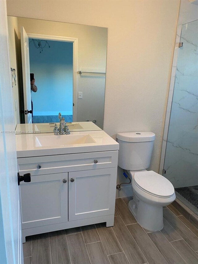 5521 SW 158th Ct, Miami, FL 33185 - bathroom featuring vanity, wood tiled floors, and a marble finish shower