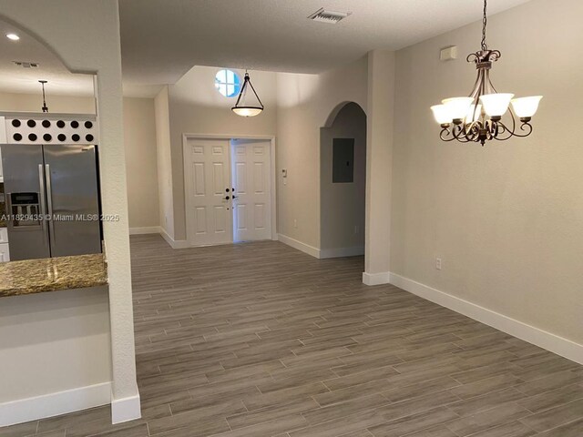 5521 SW 158th Ct, Miami, FL 33185 - entryway featuring arched walkways, wood finished floors, electric panel, and a chandelier