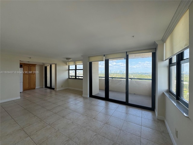 2555 Collins Ave Unit 2002, Miami Beach, FL 33140 - spare room featuring light tile patterned floors and crown molding