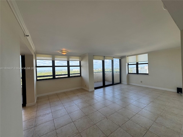 2555 Collins Ave Unit 2002, Miami Beach, FL 33140 - spare room featuring ornamental molding and light tile patterned flooring