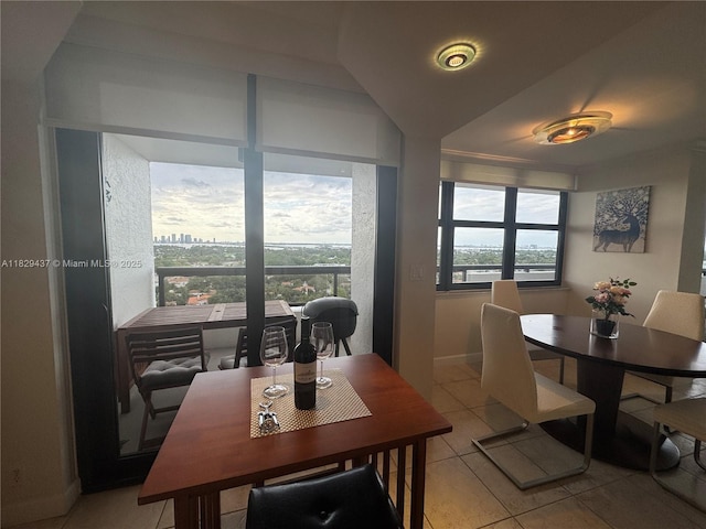 2555 Collins Ave Unit 2002, Miami Beach, FL 33140 - dining room featuring light tile patterned flooring and baseboards