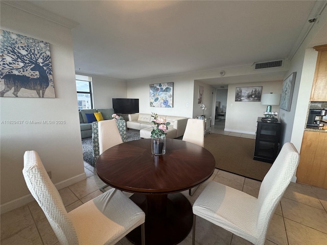 2555 Collins Ave Unit 2002, Miami Beach, FL 33140 - dining space with light tile patterned floors and crown molding