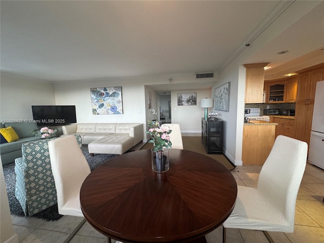2555 Collins Ave Unit 2002, Miami Beach, FL 33140 - dining room featuring light tile patterned flooring and crown molding