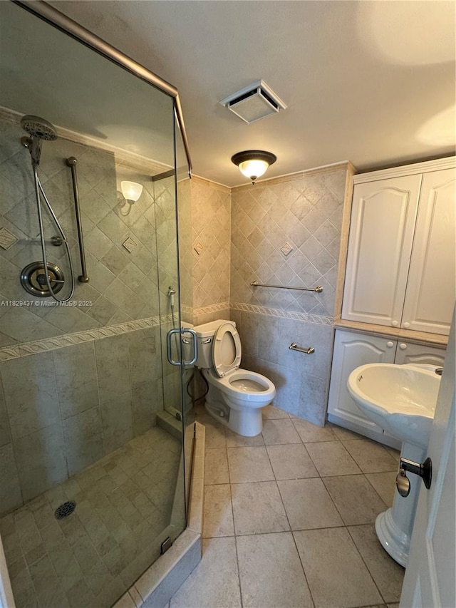 2555 Collins Ave Unit 2002, Miami Beach, FL 33140 - full bathroom with tile walls, a shower stall, and tile patterned floors
