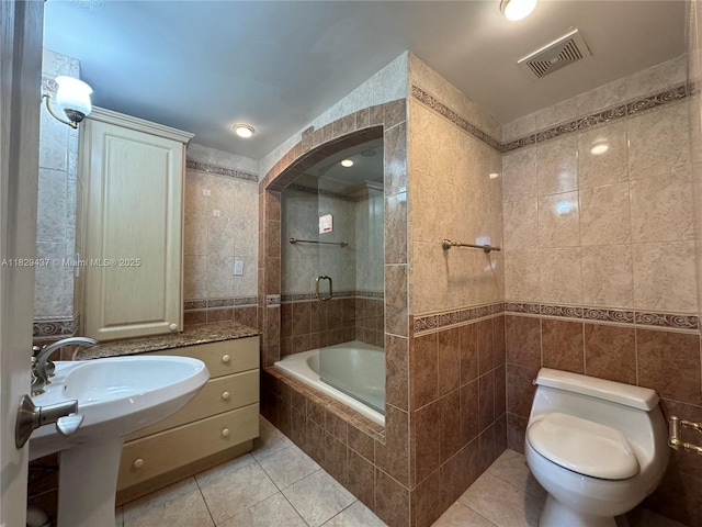 2555 Collins Ave Unit 2002, Miami Beach, FL 33140 - full bathroom with tile walls, tile patterned floors, and tiled shower / bath