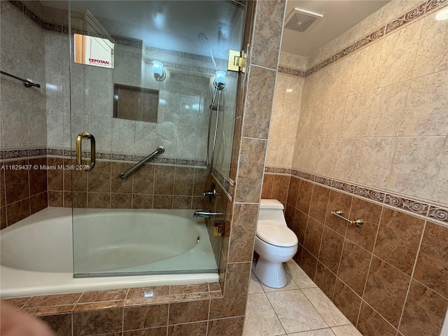 2555 Collins Ave Unit 2002, Miami Beach, FL 33140 - bathroom featuring tile walls, tiled shower / bath combo, and tile patterned floors