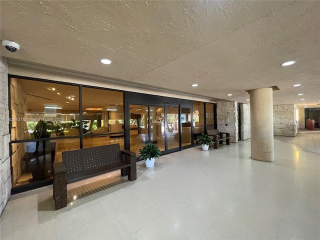 2555 Collins Ave Unit 2002, Miami Beach, FL 33140 - lobby featuring a security system, a textured ceiling, and recessed lighting