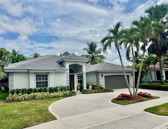2587 Jardin Ct, Weston, FL 33327 - view of front of house with a tile roof, stucco siding, decorative driveway, and a garage