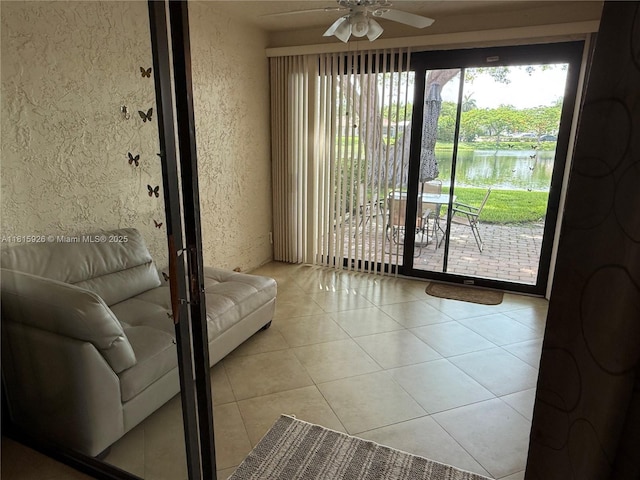 126 Centennial Ct, Deerfield Beach, FL 33442 - tiled living area with a textured wall, ceiling fan, and a water view