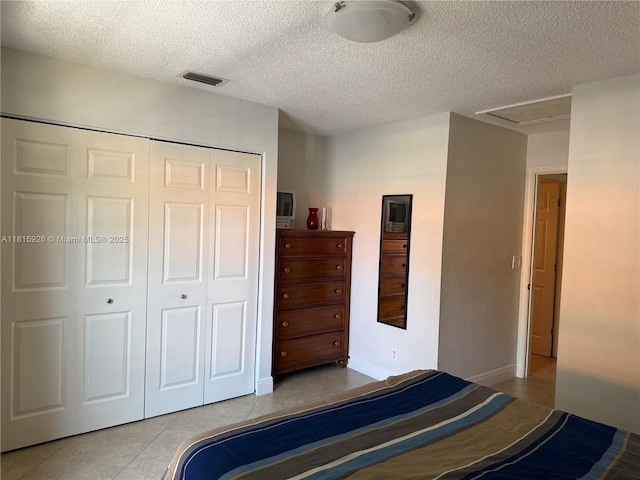 126 Centennial Ct, Deerfield Beach, FL 33442 - bedroom with light tile patterned flooring, a closet, and a textured ceiling