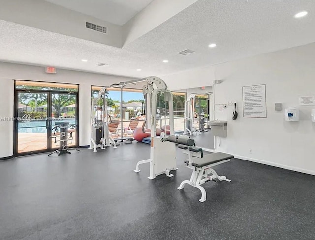 126 Centennial Ct, Deerfield Beach, FL 33442 - gym with a textured ceiling, recessed lighting, and healthy amount of natural light