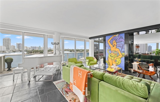 900 Bay Dr Unit 702/704, Miami Beach, FL 33141 - living area with a view of skyline, marble look tile flooring, and a water view