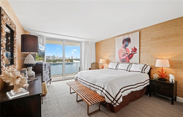900 Bay Dr Unit 702/704, Miami Beach, FL 33141 - carpeted bedroom with access to exterior and a wall of windows