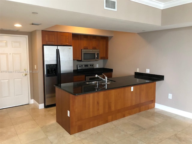 4100 Salzedo St Unit 505, Coral Gables, FL 33146 - kitchen featuring appliances with stainless steel finishes, a peninsula, brown cabinets, crown molding, and recessed lighting