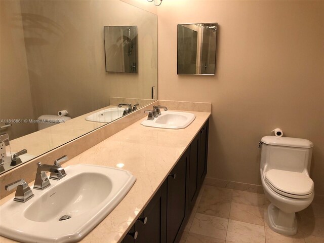 4100 Salzedo St Unit 505, Coral Gables, FL 33146 - bathroom featuring marble look tiles and double vanity