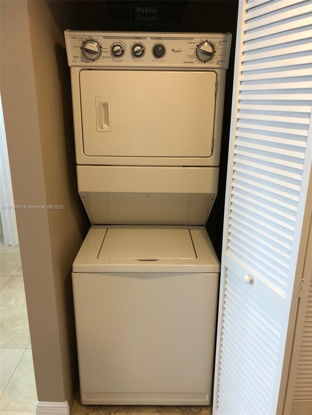 4100 Salzedo St Unit 505, Coral Gables, FL 33146 - laundry area with stacked washer and clothes dryer and light tile patterned floors