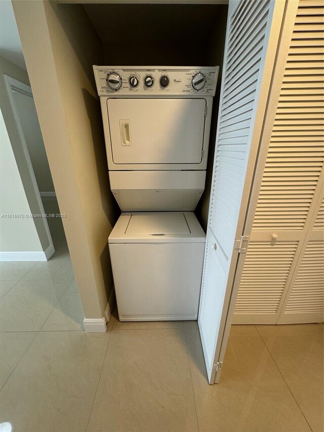 4100 Salzedo St Unit 910, Coral Gables, FL 33146 - washroom featuring stacked washer / dryer and light tile patterned floors