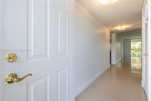3150 W Rolling Hills Cir Unit 307, Davie, FL 33328 - hallway featuring baseboards and light tile patterned floors