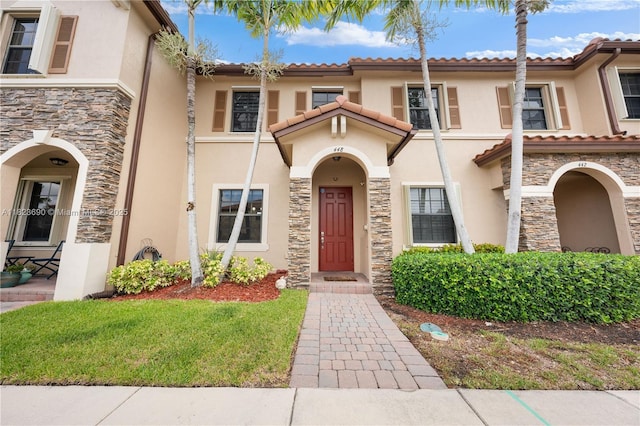 448 SE 32nd Ave, Homestead, FL 33033 - view of front facade with stucco siding, stone siding, and a tiled roof