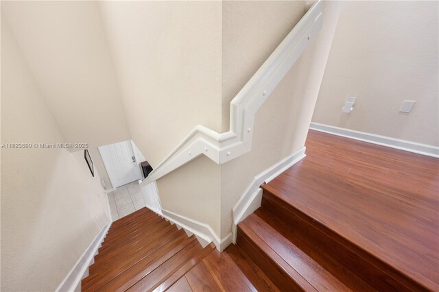 448 SE 32nd Ave, Homestead, FL 33033 - staircase featuring wood-type flooring and baseboards
