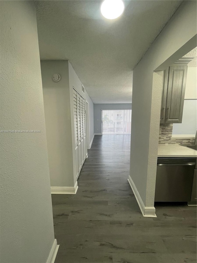 365 NE 125th St Unit 302, North Miami, FL 33161 - hallway with dark wood finished floors, a textured ceiling, and a textured wall