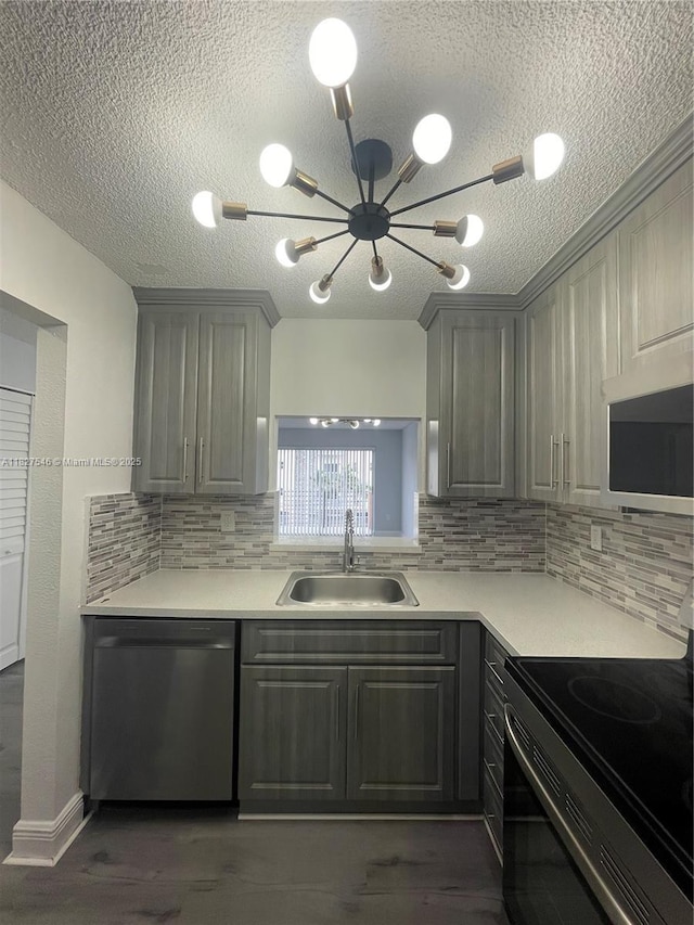 365 NE 125th St Unit 302, North Miami, FL 33161 - kitchen with appliances with stainless steel finishes, gray cabinets, a chandelier, a textured ceiling, and light countertops