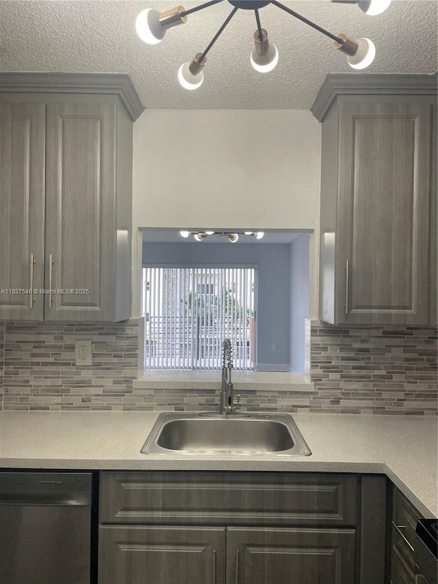 365 NE 125th St Unit 302, North Miami, FL 33161 - kitchen featuring dishwasher, a textured ceiling, light countertops, gray cabinetry, and backsplash
