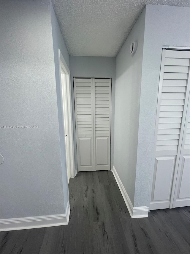 365 NE 125th St Unit 302, North Miami, FL 33161 - hall featuring dark wood finished floors and a textured ceiling