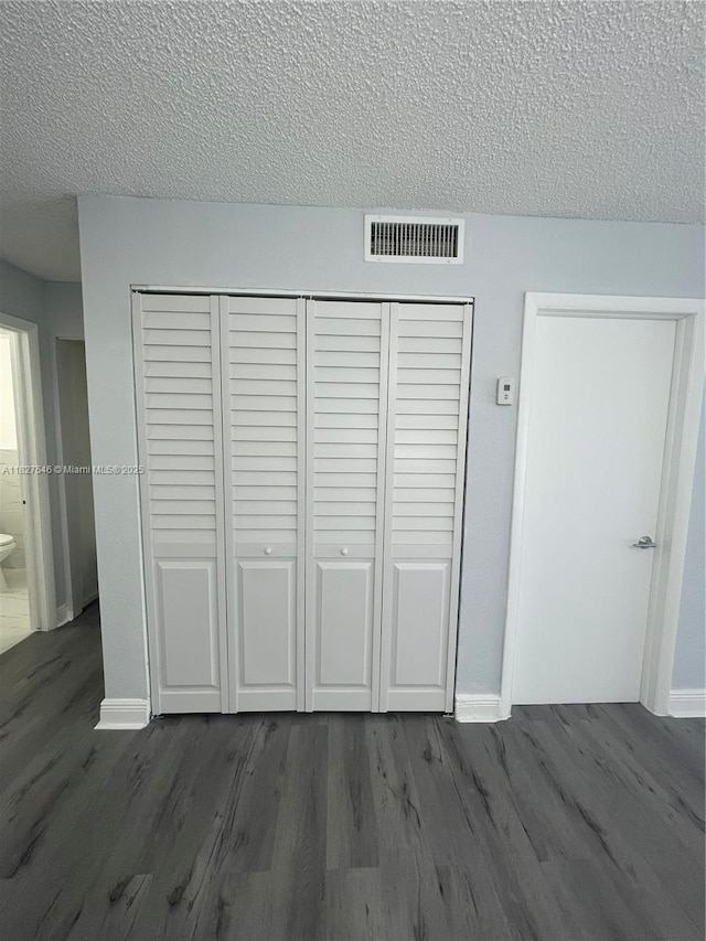 365 NE 125th St Unit 302, North Miami, FL 33161 - detailed view of wood finished floors and a textured ceiling