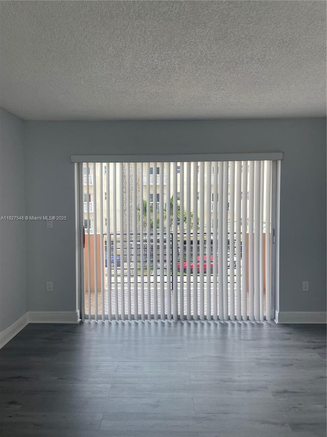 365 NE 125th St Unit 302, North Miami, FL 33161 - unfurnished room with wood finished floors and a textured ceiling