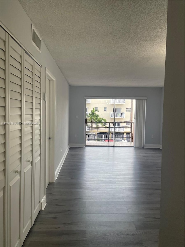 365 NE 125th St Unit 302, North Miami, FL 33161 - unfurnished living room with a textured ceiling and dark wood-style floors