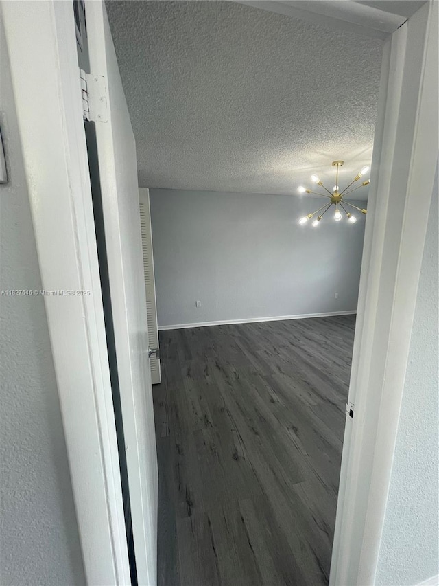 365 NE 125th St Unit 302, North Miami, FL 33161 - unfurnished room featuring wood finished floors, a textured ceiling, and a chandelier