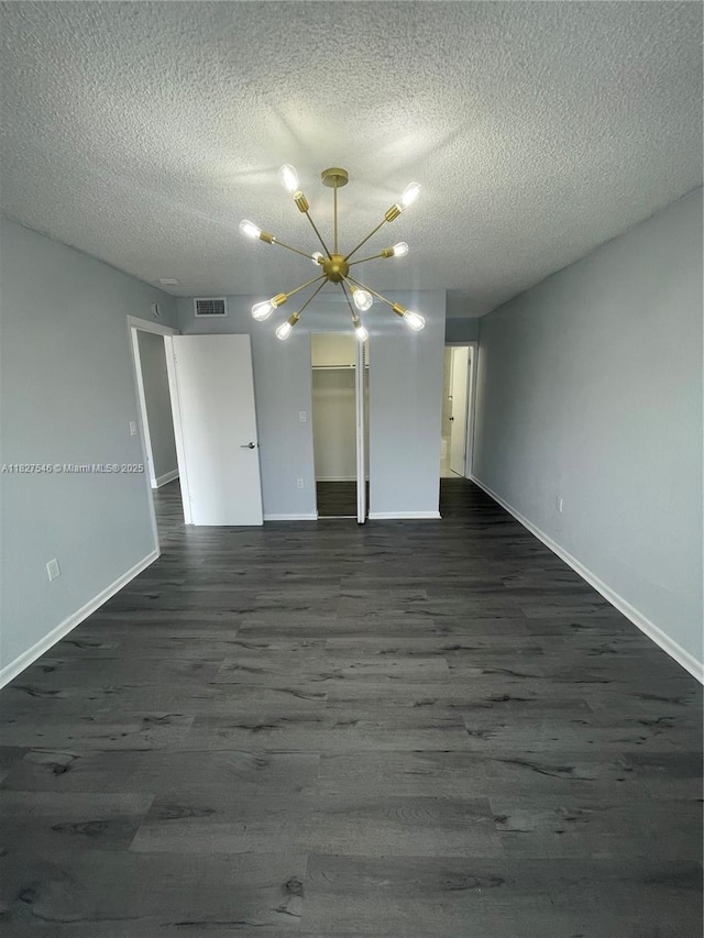 365 NE 125th St Unit 302, North Miami, FL 33161 - unfurnished room featuring a chandelier, dark wood finished floors, and a textured ceiling