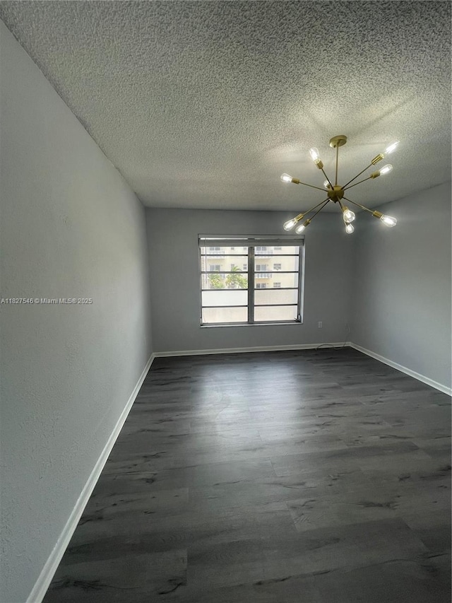 365 NE 125th St Unit 302, North Miami, FL 33161 - unfurnished room with a chandelier, dark wood-style flooring, and a textured ceiling