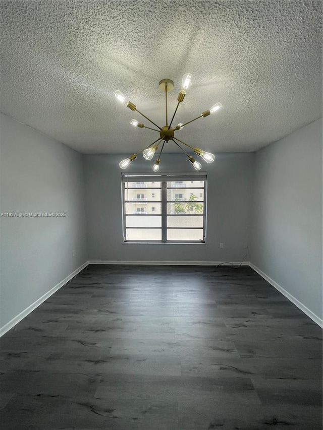 365 NE 125th St Unit 302, North Miami, FL 33161 - empty room featuring a chandelier, dark wood-type flooring, and a textured ceiling