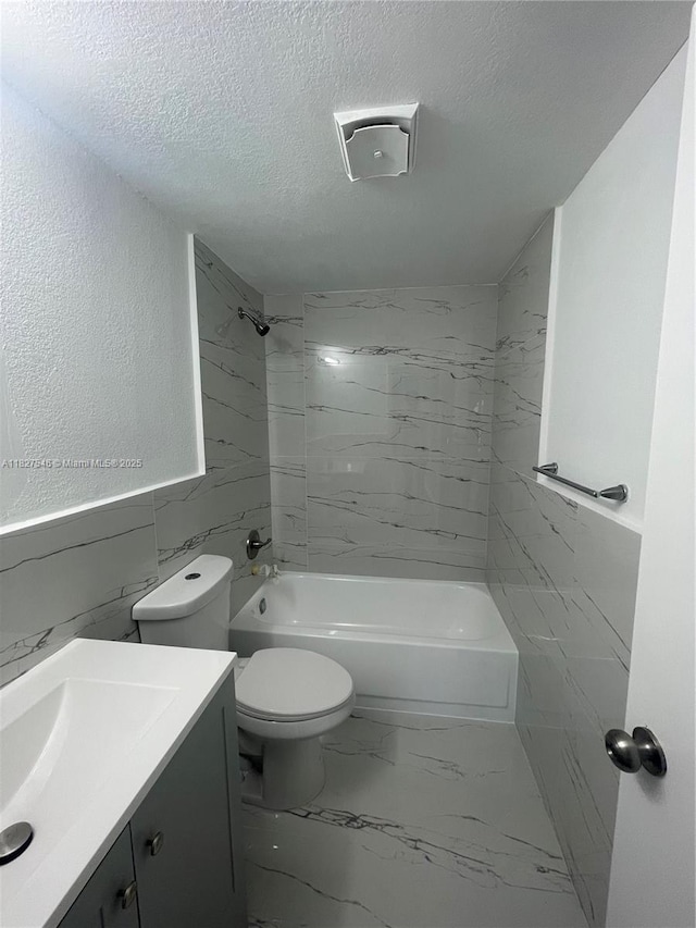 365 NE 125th St Unit 302, North Miami, FL 33161 - bathroom with vanity, a textured ceiling, shower / washtub combination, marble finish flooring, and wainscoting