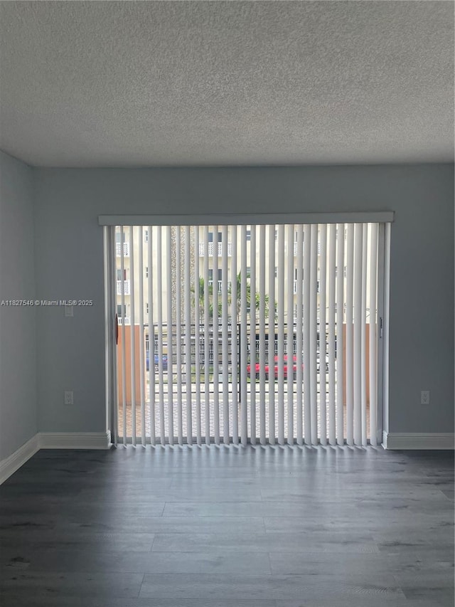 365 NE 125th St Unit 302, North Miami, FL 33161 - spare room with wood finished floors and a textured ceiling