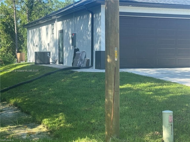3003 18th St W, Lehigh Acres, FL 33976 - view of side of home with a yard, a garage, and concrete driveway