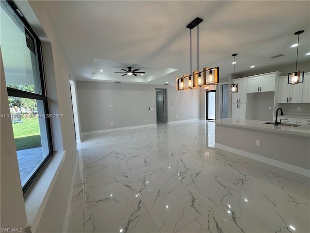 3003 18th St W, Lehigh Acres, FL 33976 - unfurnished living room featuring a tray ceiling, a ceiling fan, light marble finish flooring, and recessed lighting