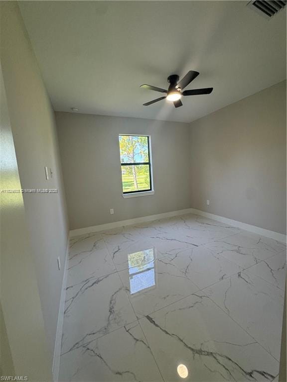 3003 18th St W, Lehigh Acres, FL 33976 - unfurnished room featuring marble finish flooring and ceiling fan
